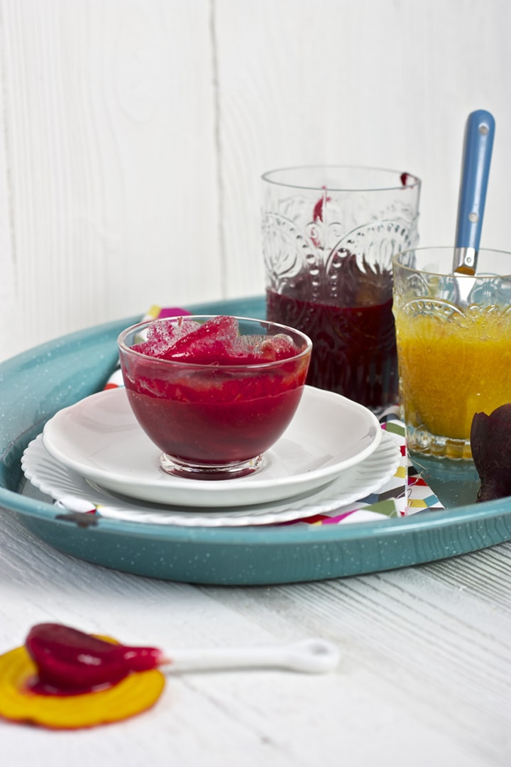 Blue tray with jars filled with different beet purees.