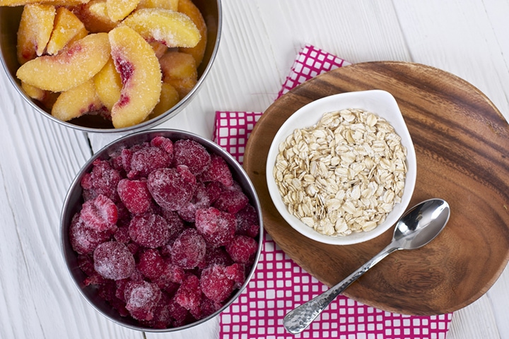 Produce and oats spread on a white board.