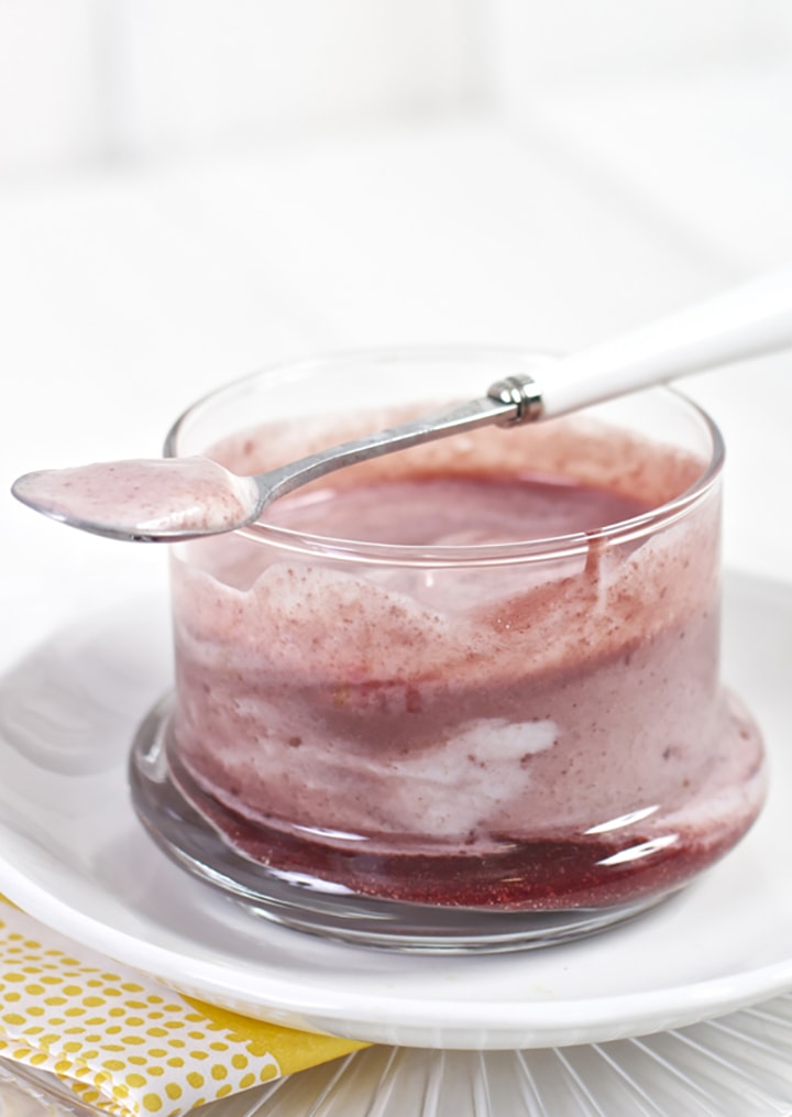 Clear cup with a baby food puree and yogurt inside.
