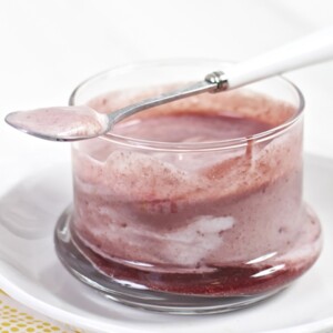 Clear cup with a baby food puree and yogurt inside.
