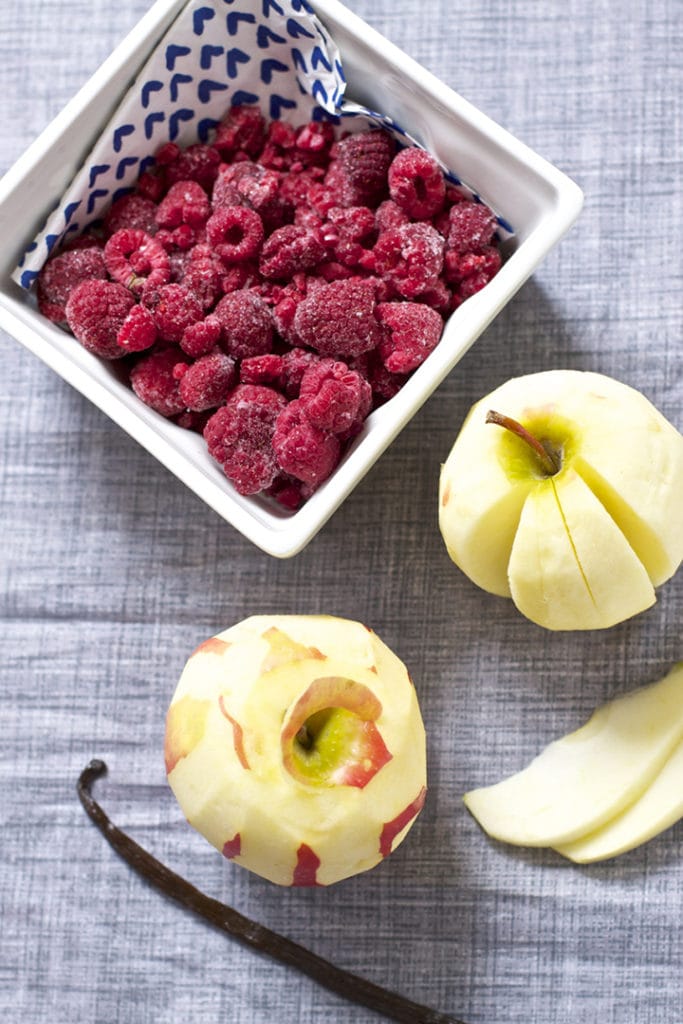 Square bowl with produce inside of it.