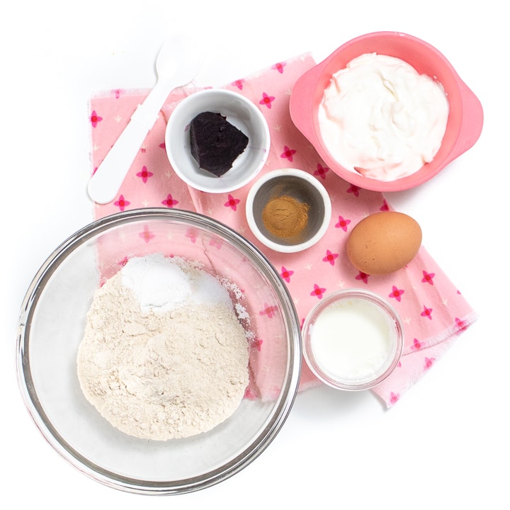 Spread of ingredients for beet pink pancakes on a pink napkin.