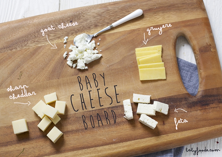 Cutting board with a selection of cheeses for baby on it. 