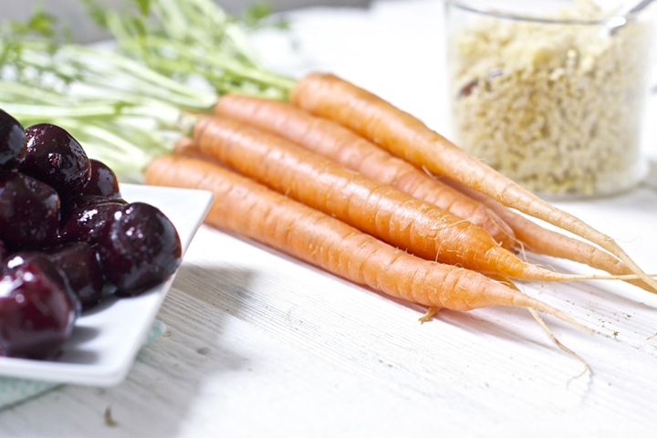 Carrots and other produce on a white background.