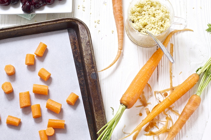 Carrots and other produce on a white background.