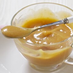 Small clear bowl filled with a thick and creamy homemade baby food puree.