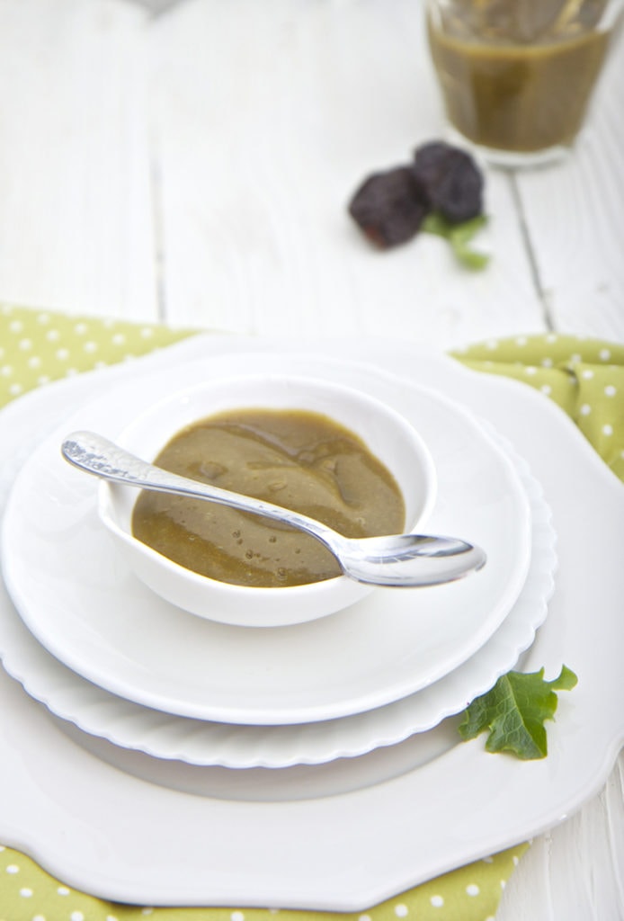 small bowl filled with the homemade puree with a spoon resting next to it filled with puree.