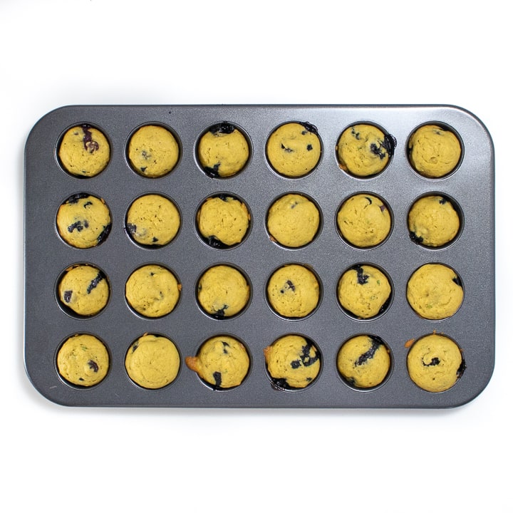 muffin pan with cooked mini muffins.