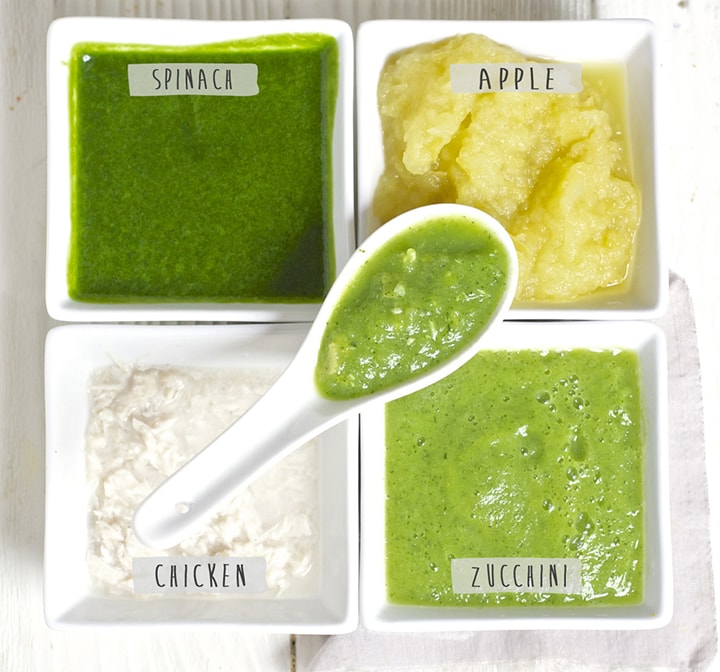 4 containers filled with different baby food purees.