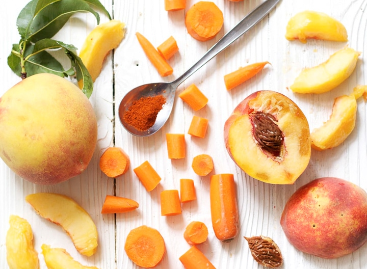 Spread of ingredients for peach and carrot baby food puree.