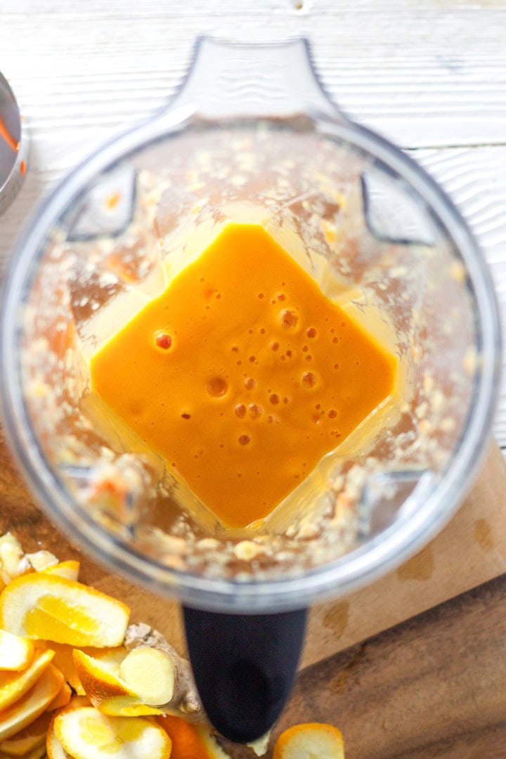Blender full of carrot and orange juice.
