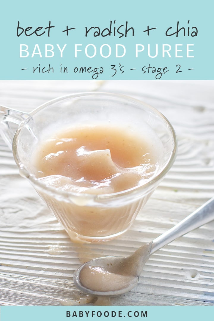 Small glass jar with a spoon resting in front filled with a soft pink baby food puree. 
