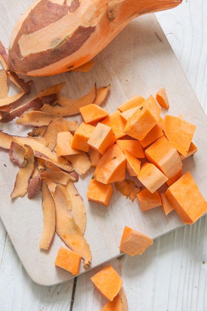 Chopped Sweet Potatoes on a cutting board.