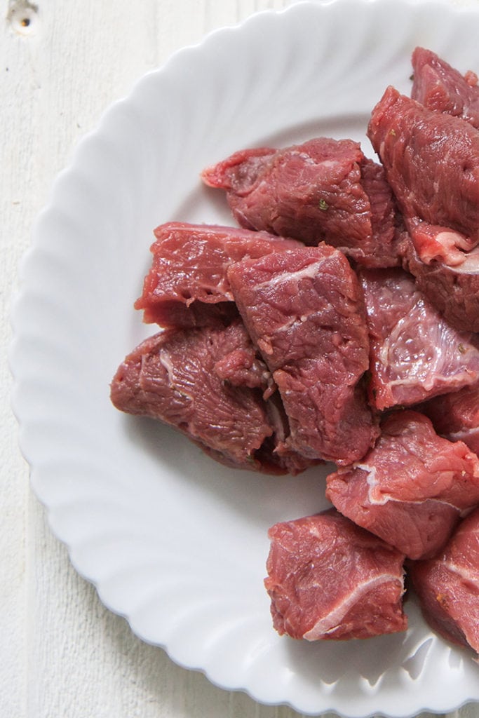 Beef on a white plate.
