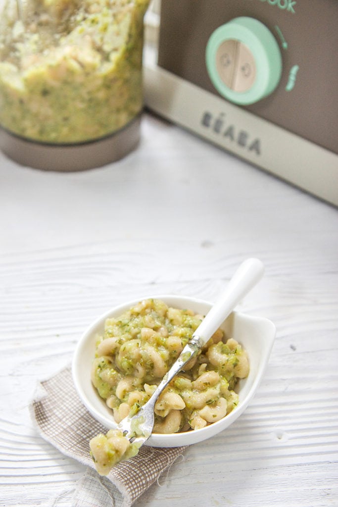 small white bowl of pasts in front of a Beaba machine.