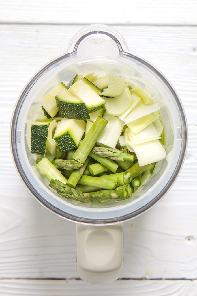 Steamer basket with green veggies inside - ready to get steamed.