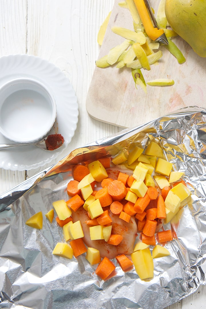 Tin foil packet with Thai chicken ingredients.