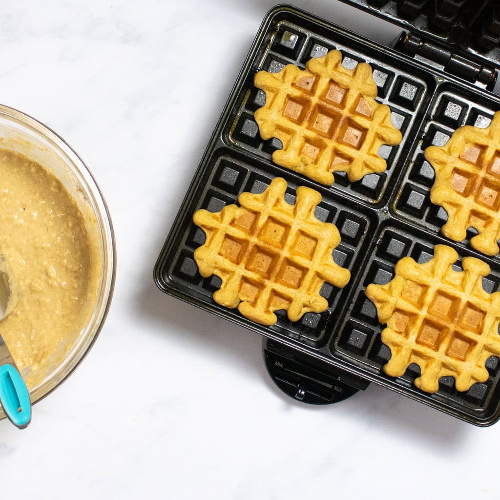 Waffle maker with sweet potato waffles being made in my kitchen.
