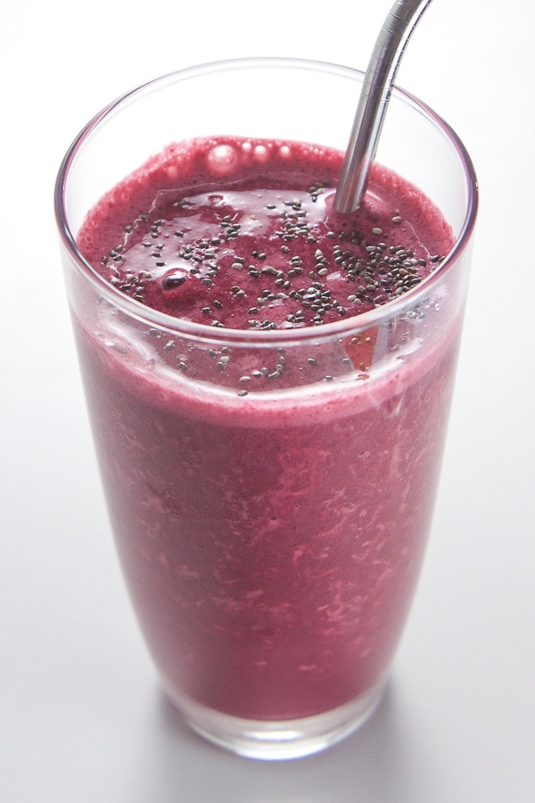 Kid friendly cherry beet smoothie in a pint glass with a metal straw.