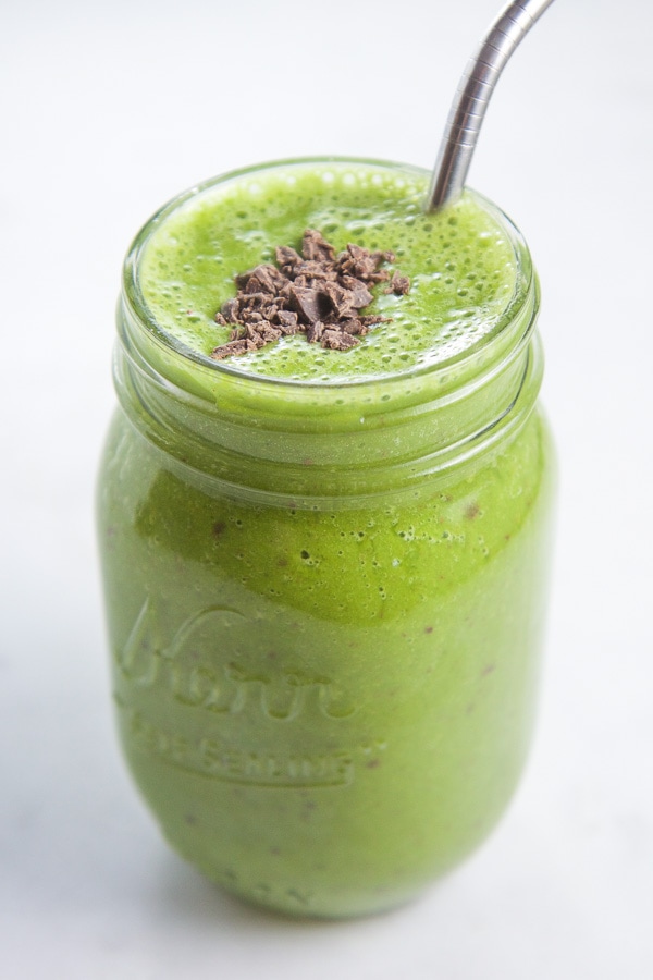 Kid friendly green mint chocolate smoothie in a mason jar.
