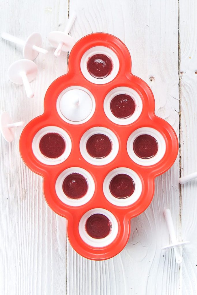 Popsicle mold filled with yogurt, baby food puree and honey.