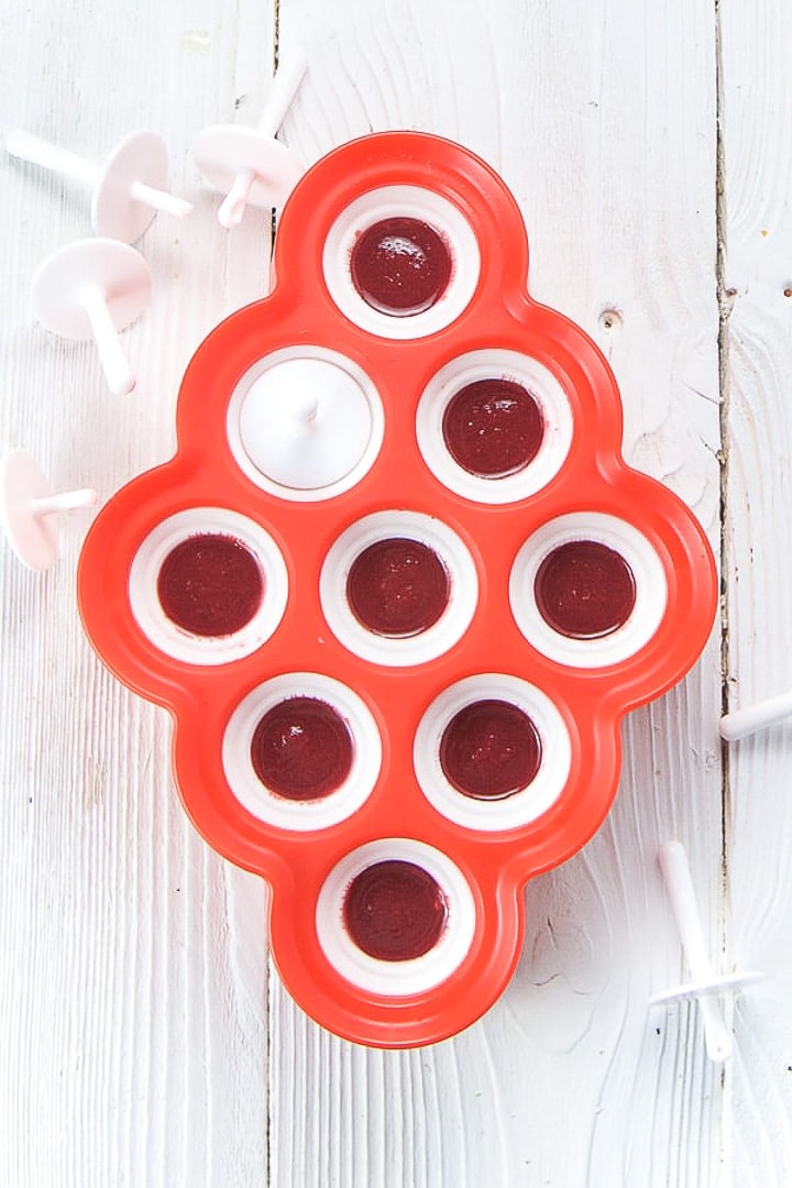 Popsicle mold filled with yogurt, baby food puree and honey.