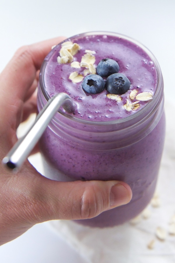 Blueberry pie smoothie in mason jar with metal straw