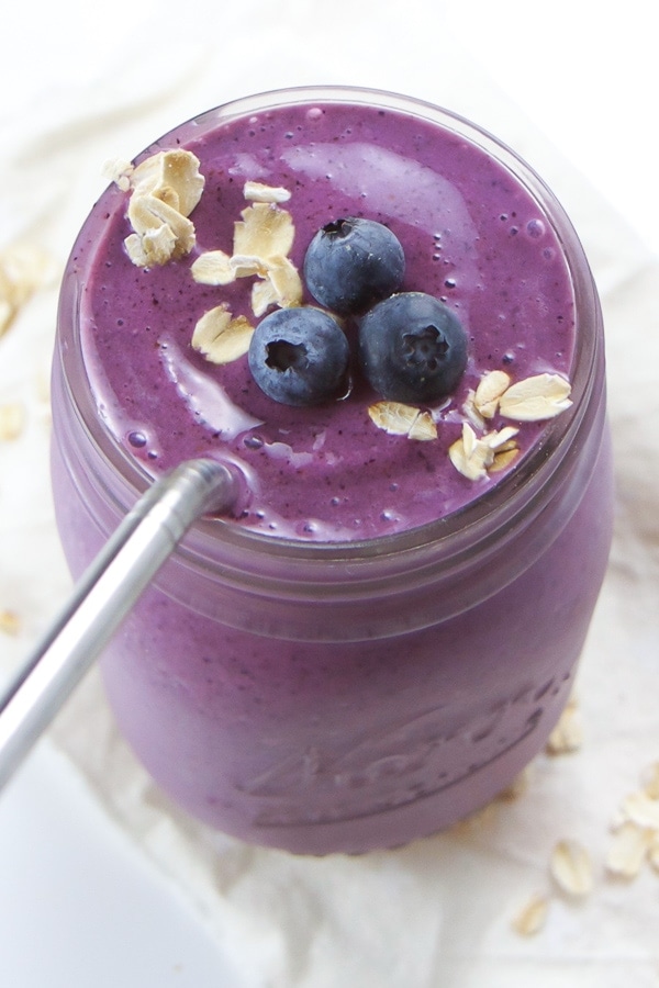 Blueberry pie smoothie in mason jar with metal straw