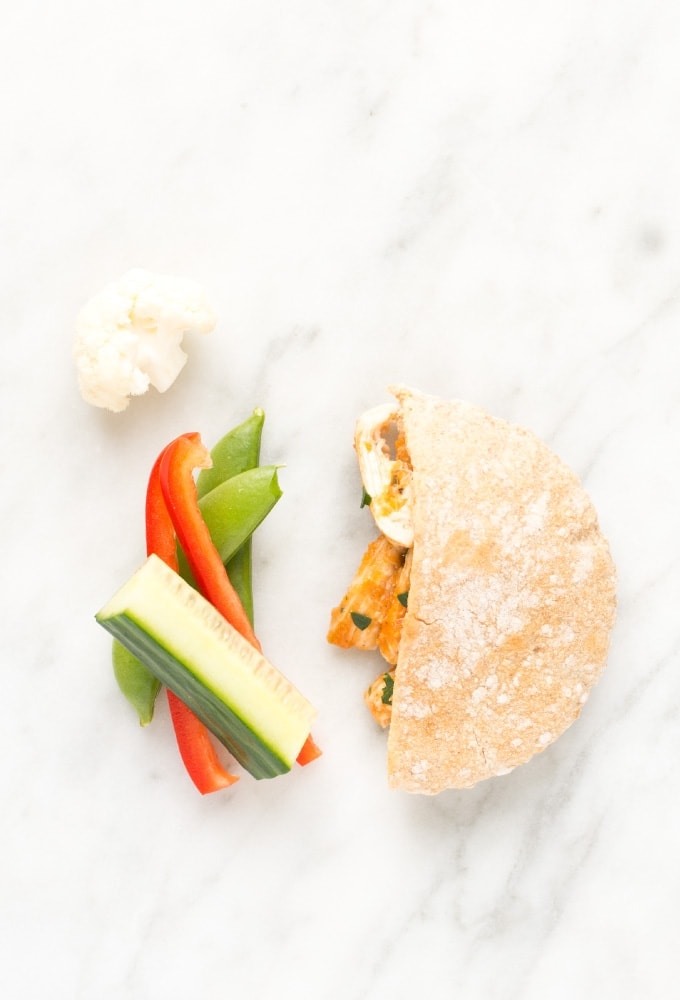 Pita, cucumber, red pepper, and peas on marble counter top