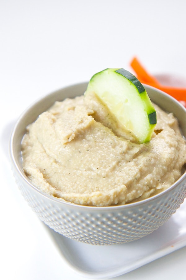 Healthy ranch hummus yogurt dip for kids and toddlers in a white bowl.