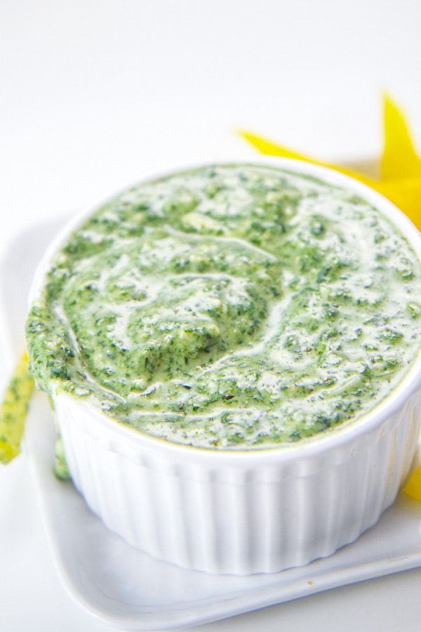 Healthy spinach basil yogurt dip for kids and toddlers in a white bowl.