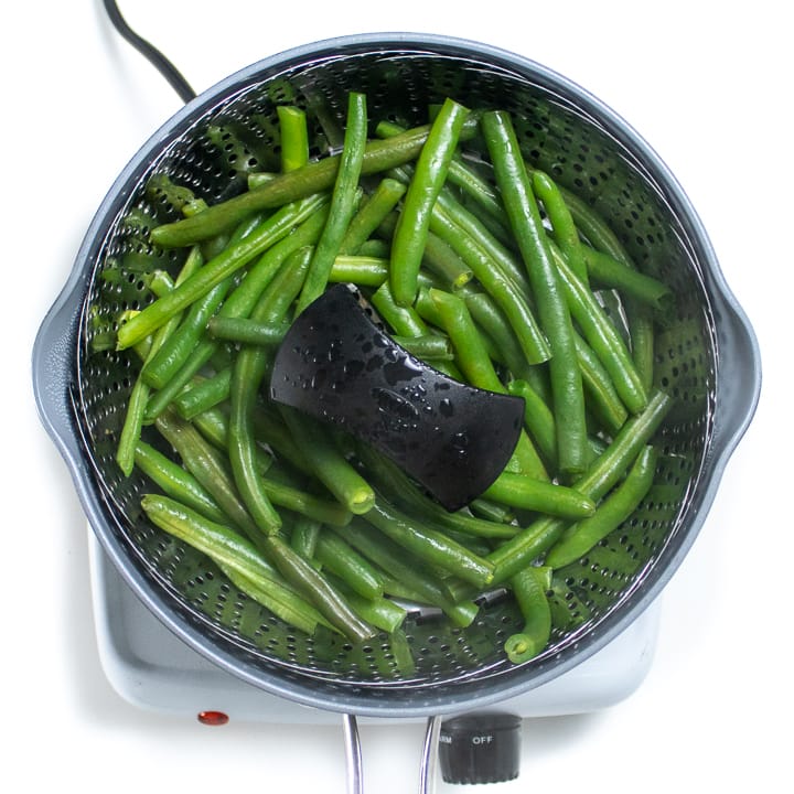 Green bean in a steamer cooking for baby puree.