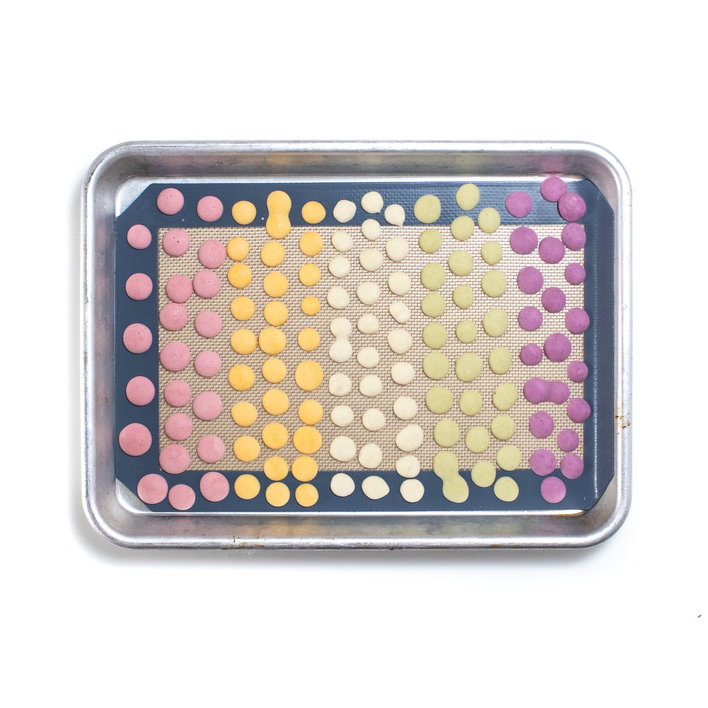 A baking sheet full of frozen colorful yogurt melts for Baby.