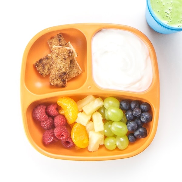 Toddler plate with cut fruit and yogurt dip