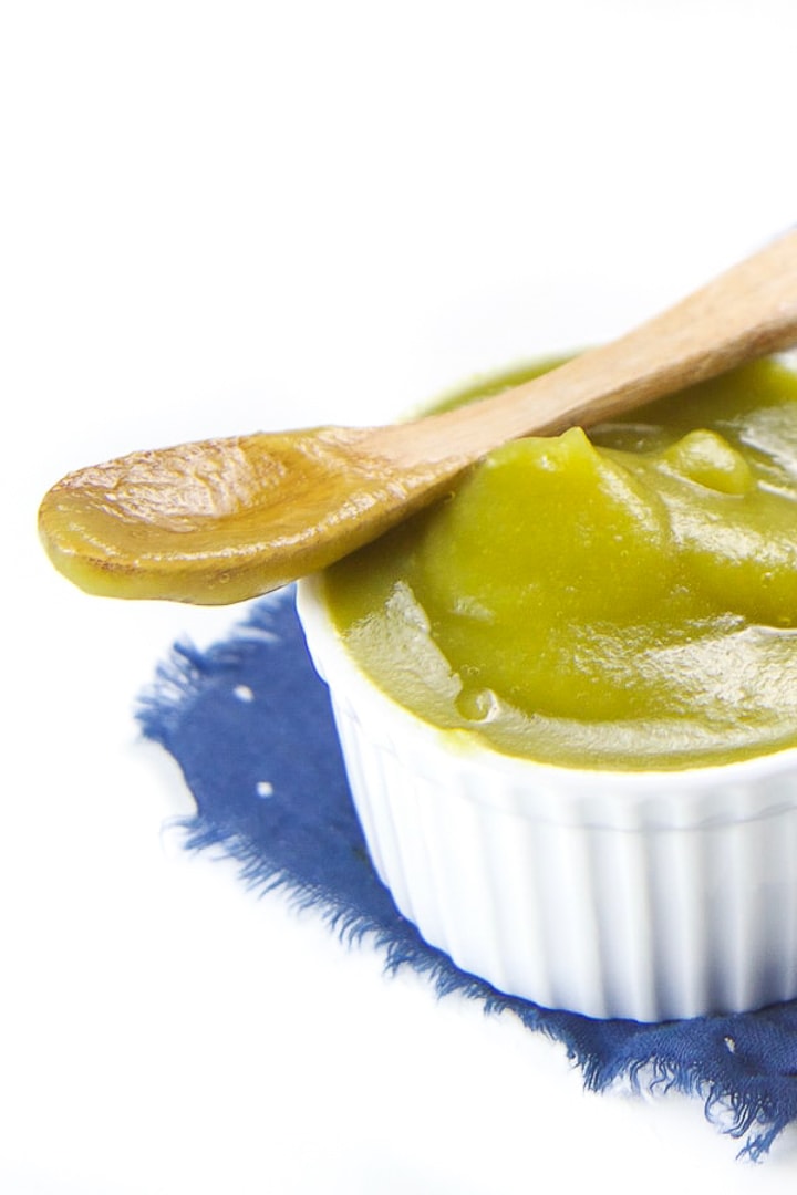 White bowl full of apple and kale baby food puree.