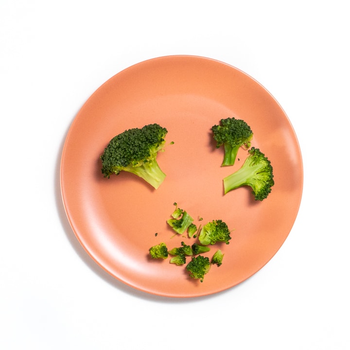 broccoli cut 3 different ways on a pink baby plate.