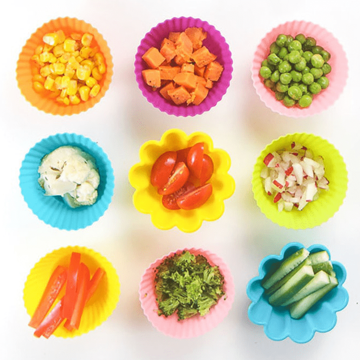 9 small baby bowls filled with small finger foods for baby.