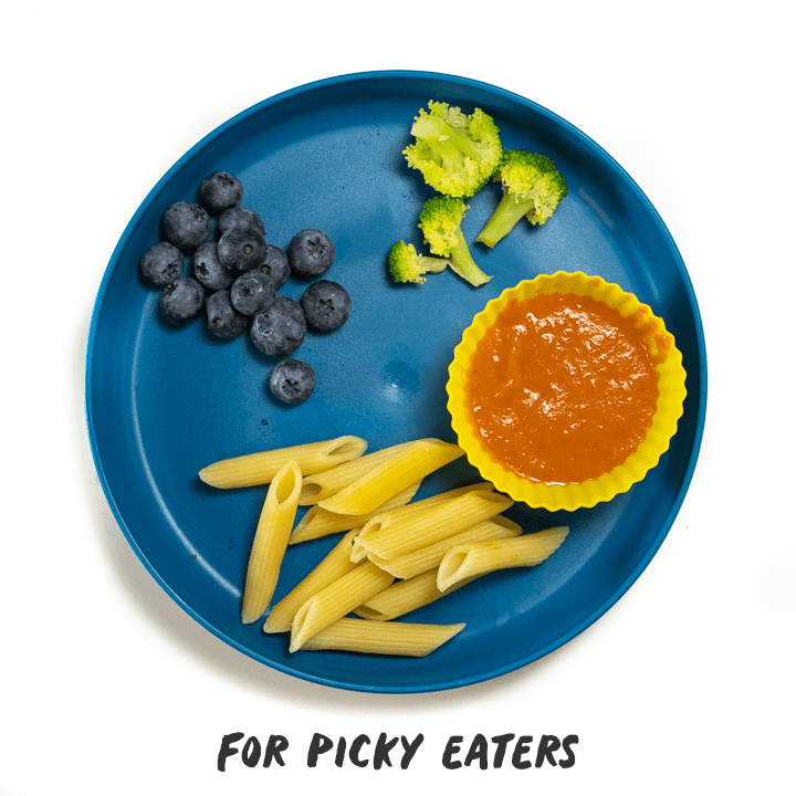 Green plate with hidden veggie pasta sauce made into a meal for picky eaters with one meal for the entire family.