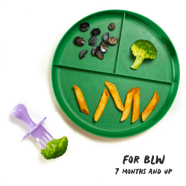 Green plate with hidden veggie pasta sauce made into a meal for baby.