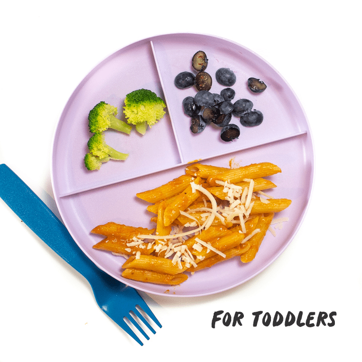 Green plate with hidden veggie pasta sauce made into a meal for toddlers to enjoy.