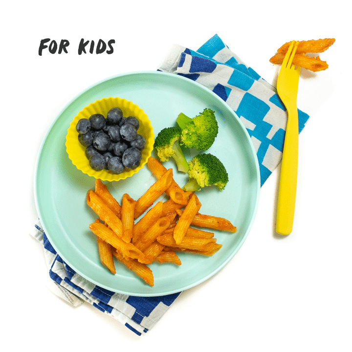 Green plate with hidden veggie pasta sauce made into a meal for kids.