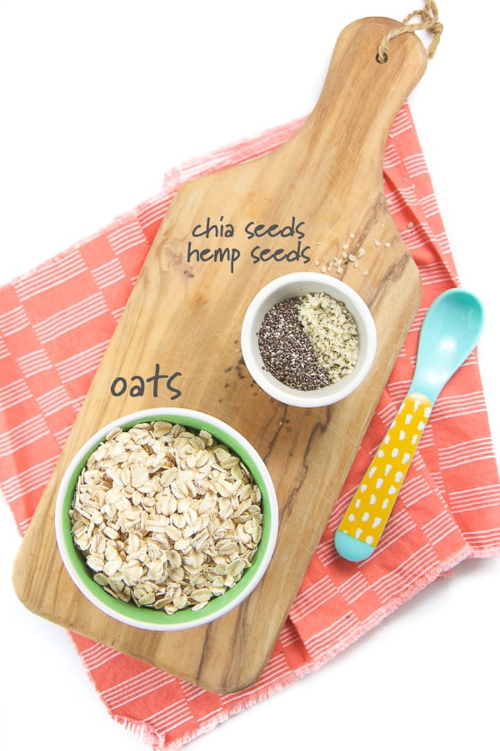 Ingredients for oatmeal for babies spread on a cutting board.