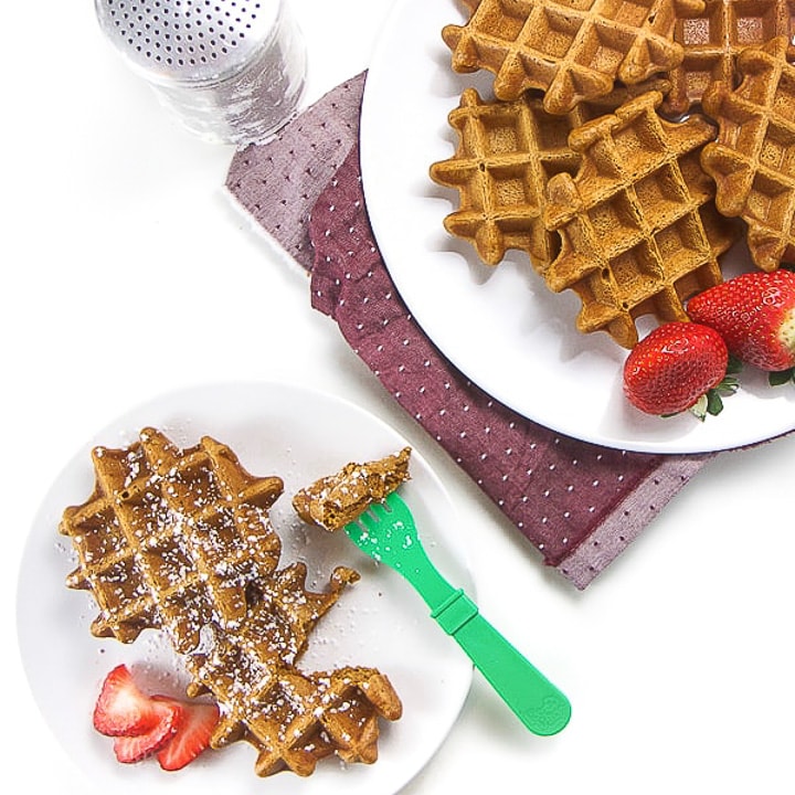 gingerbread waffles on a plate with a small one for a toddler