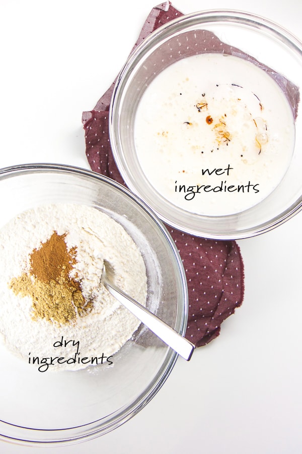 Dry ingredients and wet ingredients for gingerbread waffles in two separate bowls.