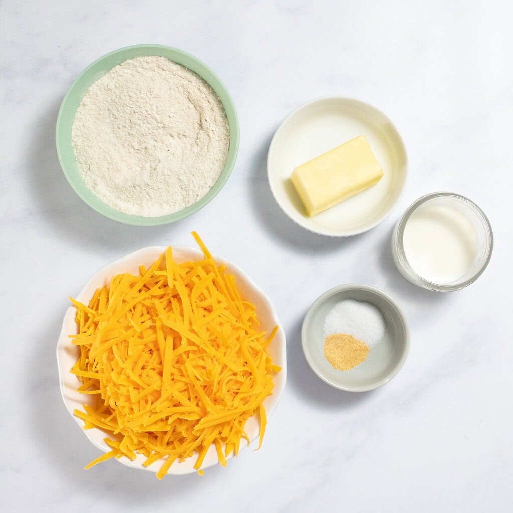 Ingredients needed for homemade cheez its - flour, butter, shredded cheese, salt, spices and milk.