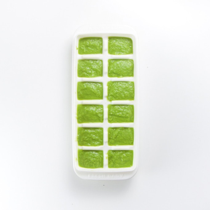 white freezer tray sitting on a white background filled with a creamy green organic green bean baby food recipe