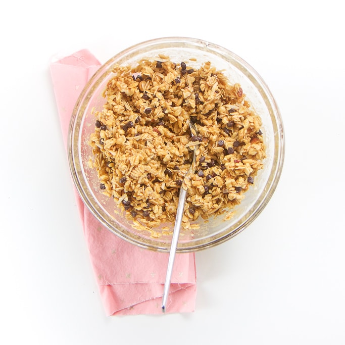 overhead shot of the glass bowl filled with all of the mixed ingredients. The bowl is sitting on top of a pink napkin on a white background.