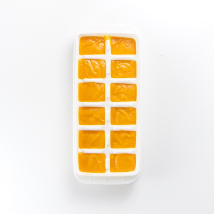 a white freezer tray filled with sweet potato baby food puree