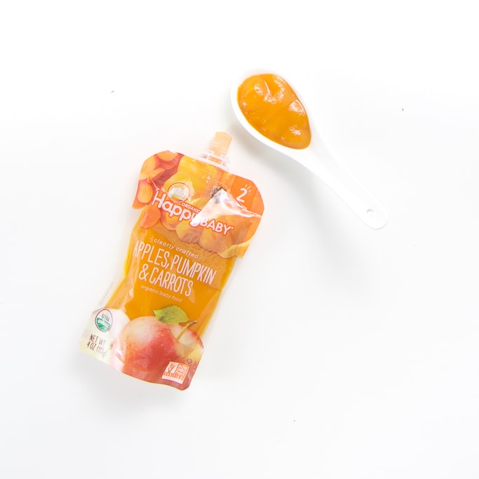 One pouch with a spoon filled with it's puree