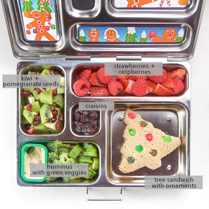 A silver planetbox lunch box filled with christmas tree sandwich and other holiday themed foods for kids.